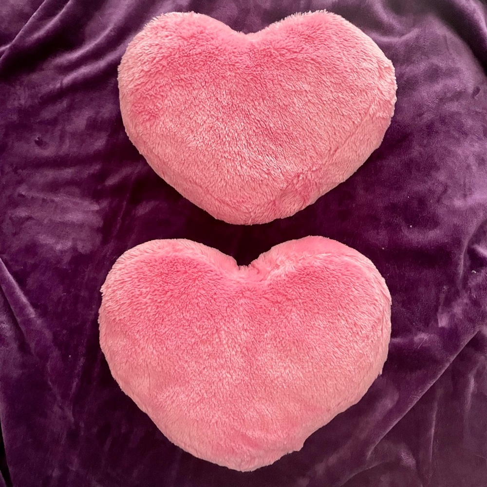 Set of two pink heart pillows. Gently used. 13” x 9”